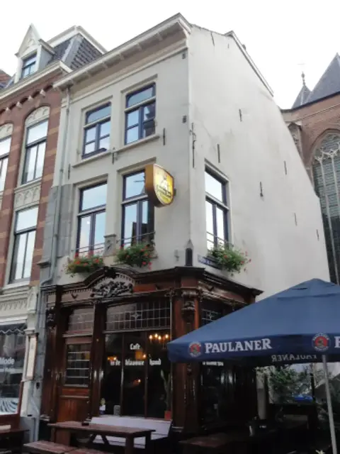 The corner of Café in de Blaauwe Hand with its name carved across the timber shopfront
