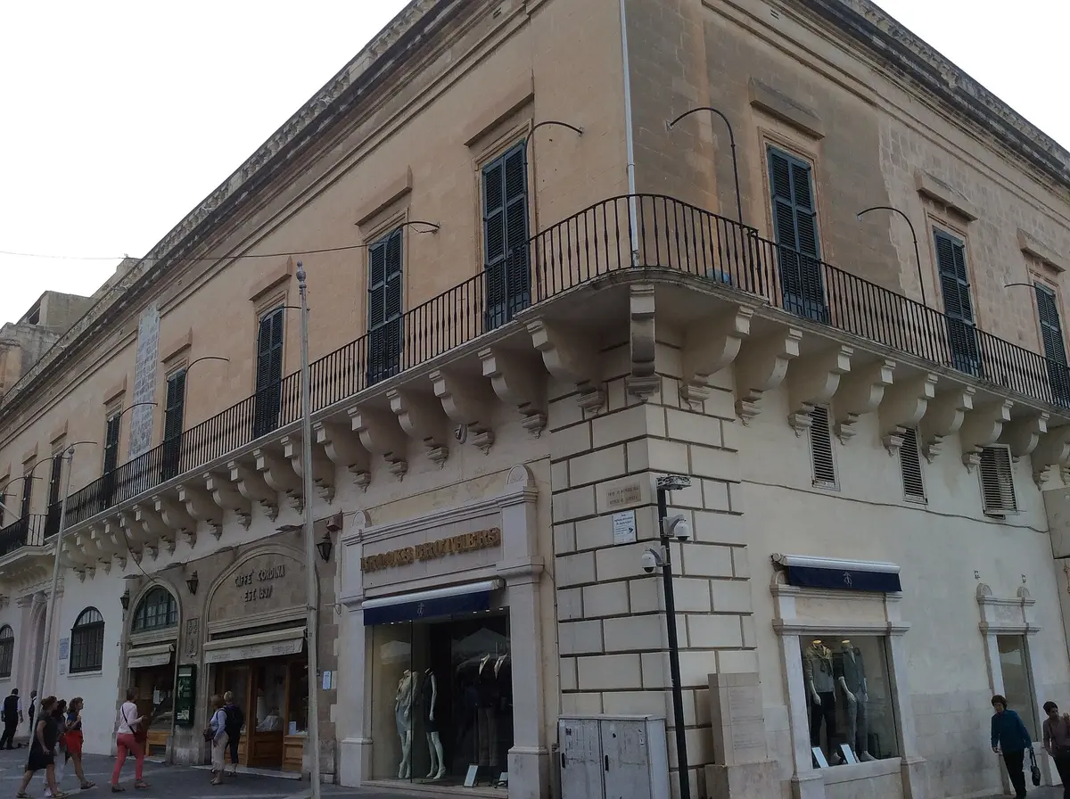 Corner palace on Republic Street with CAFFÈ CORDINA EST 1837 lettered over its arched shopfront