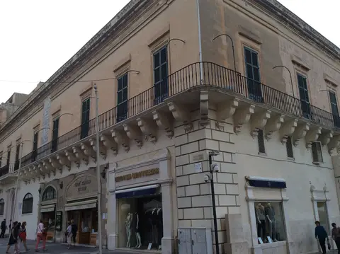 Corner palace on Republic Street with CAFFÈ CORDINA EST 1837 lettered over its arched shopfront