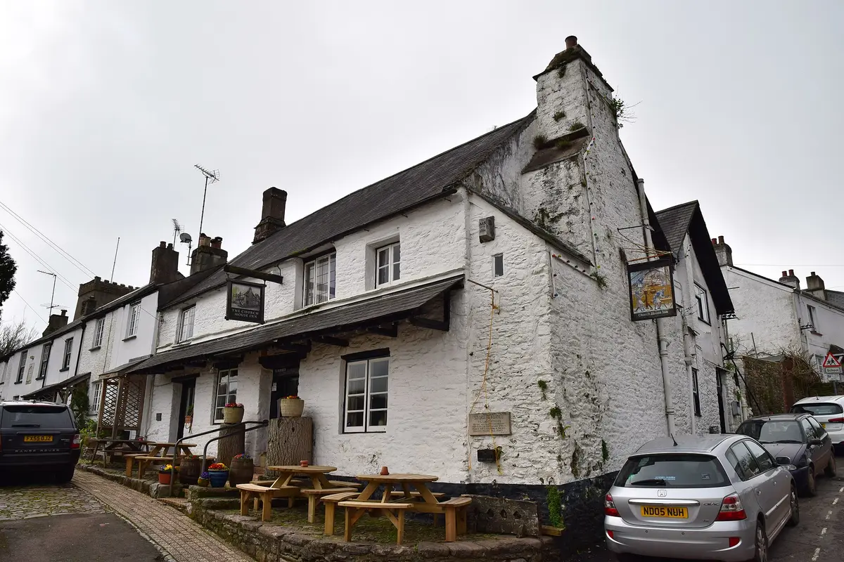 The Church House Inn at Stoke Gabriel, its great whitewashed chimney breast rising above the street