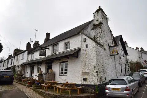 The Church House Inn at Stoke Gabriel, its great whitewashed chimney breast rising above the street
