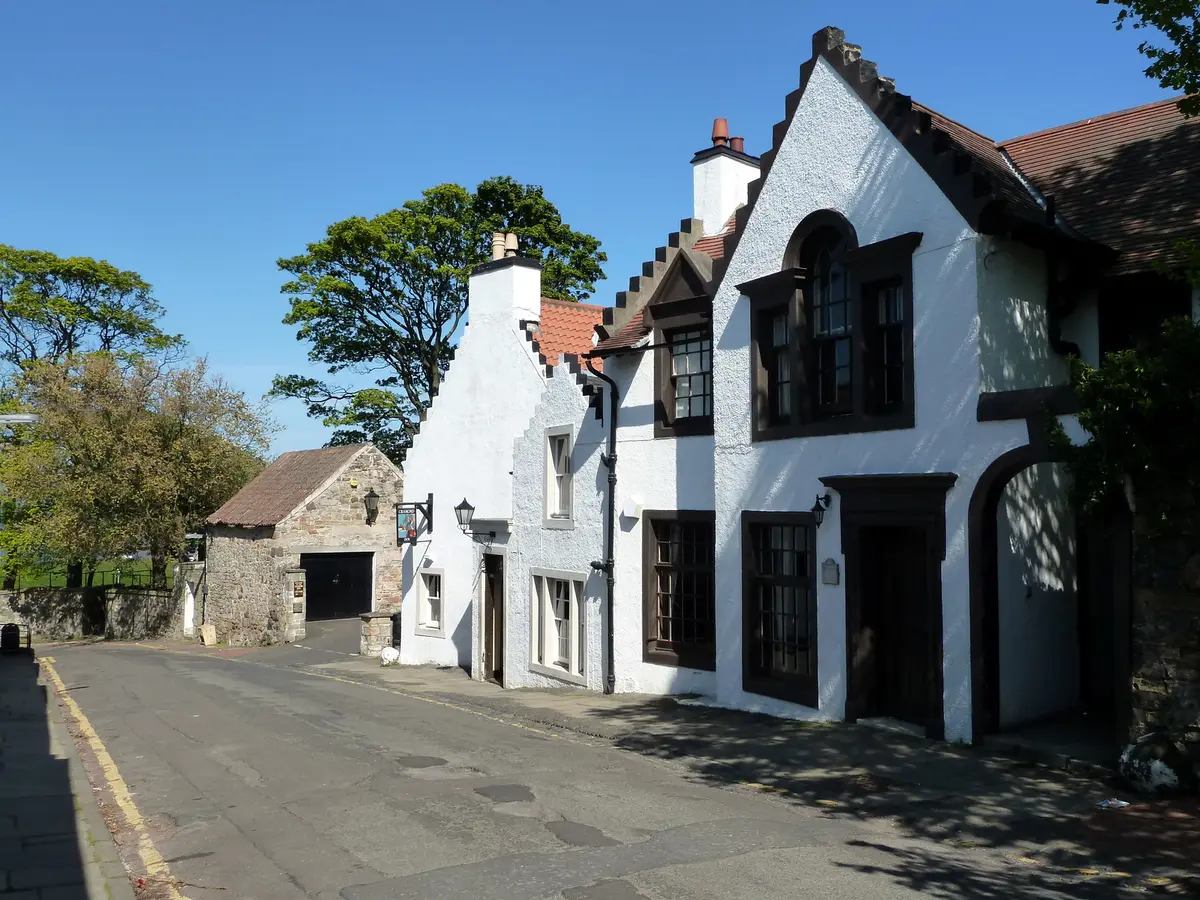 The white crow-stepped Cramond Inn on the village street, its hanging sign on a bracket beside the door