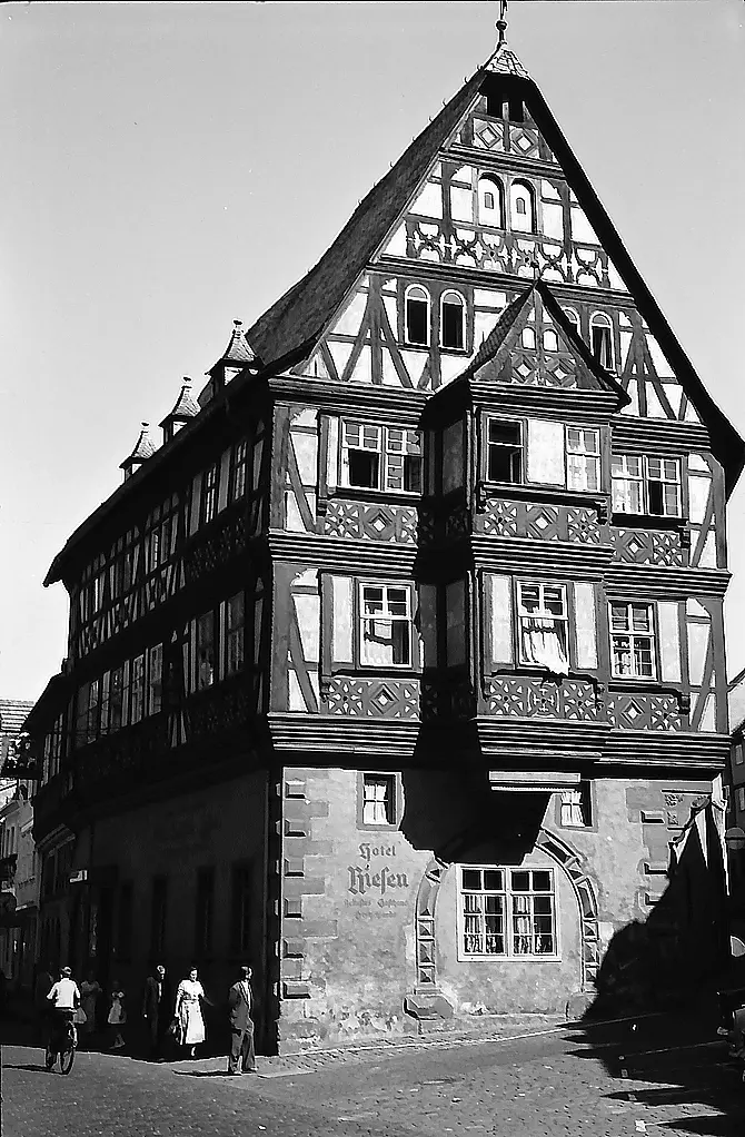 The Riesen in 1960: carved timber frame above a stone ground floor with 'Hotel Riesen' painted across it