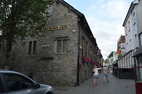 Kyteler’s Inn on a Kilkenny corner, gilt lettering across the stone gable and its hanging sign beyond