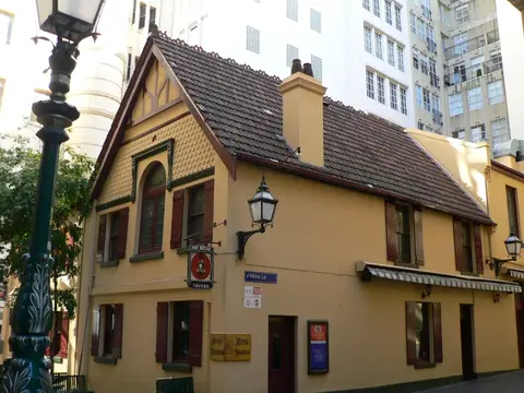 The Mitre Tavern’s yellow gabled building in Bank Place, Melbourne, with its hanging sign