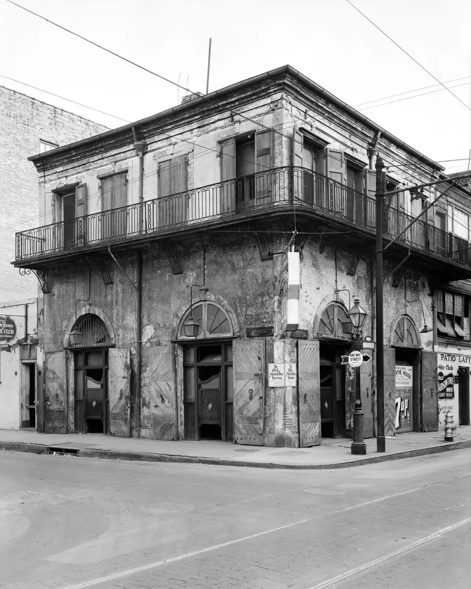 The Old Absinthe House in 1937, shuttered and stripped, its stucco falling away at the corner of Bourbon Street