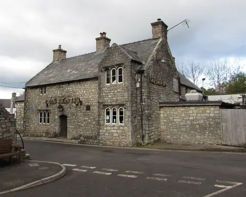 Corner view of the inn showing both ranges, three chimney stacks and its two name boards