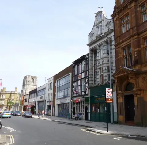 Southampton High Street looking north, the timber-framed pub set among later brick and stone frontages