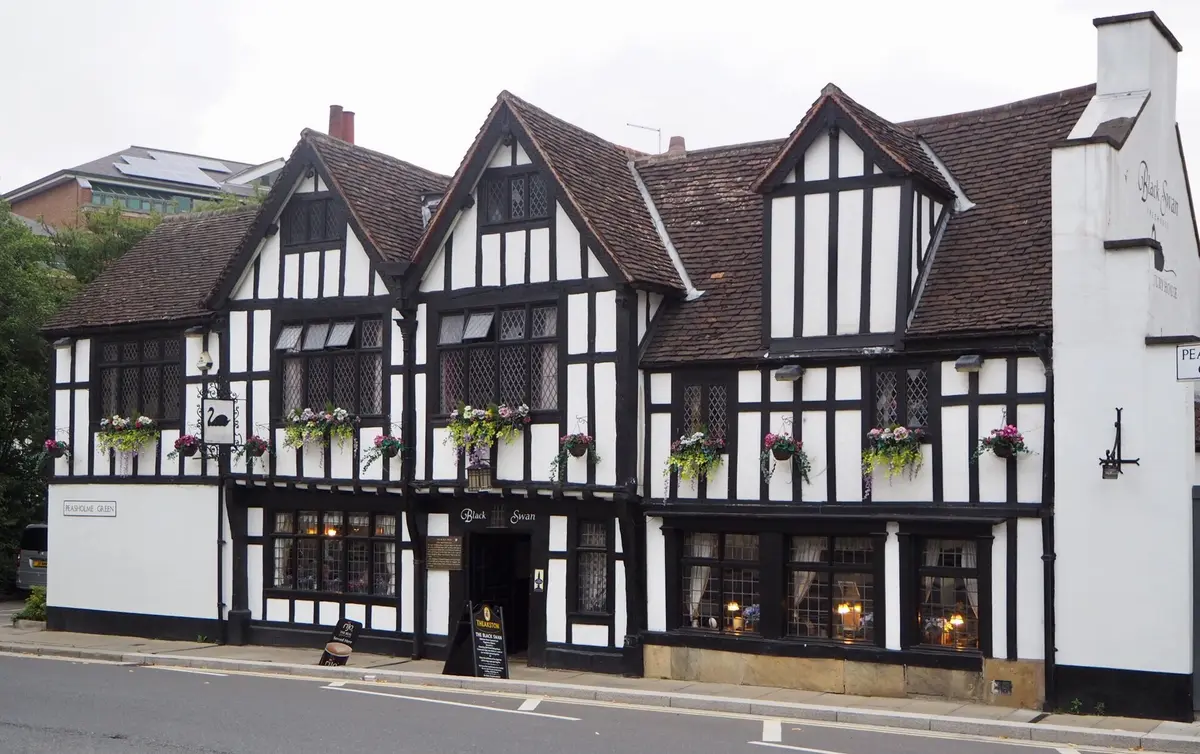 The timber-framed front of the Black Swan at York, three gables of black frame and white panels