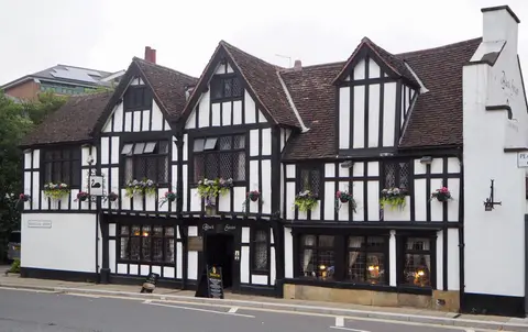 The timber-framed front of the Black Swan at York, three gables of black frame and white panels
