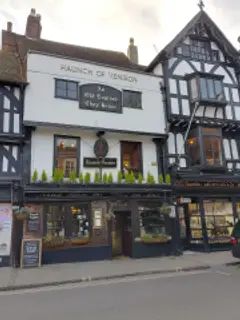 White-painted three-storey front lettered Haunch of Venison above a board reading An Old English Chop House
