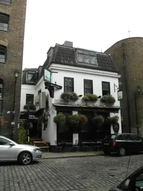 The Mayflower at Rotherhithe, its name in gold on the black front, hanging baskets either side
