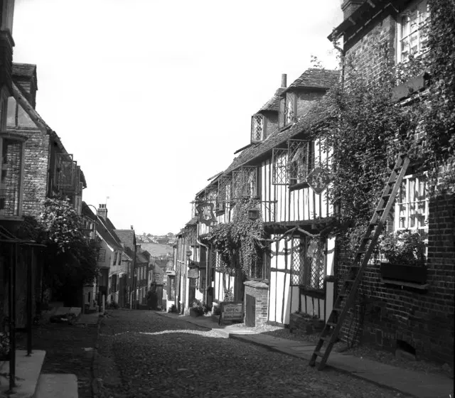 Cobbled Mermaid Street in 1955, empty of cars, with the timber-framed front of the Mermaid Inn on the right