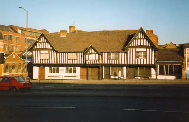 The Old Crown in 1991, its timber front intact but the ground floor whitewashed and shuttered, seen across the road