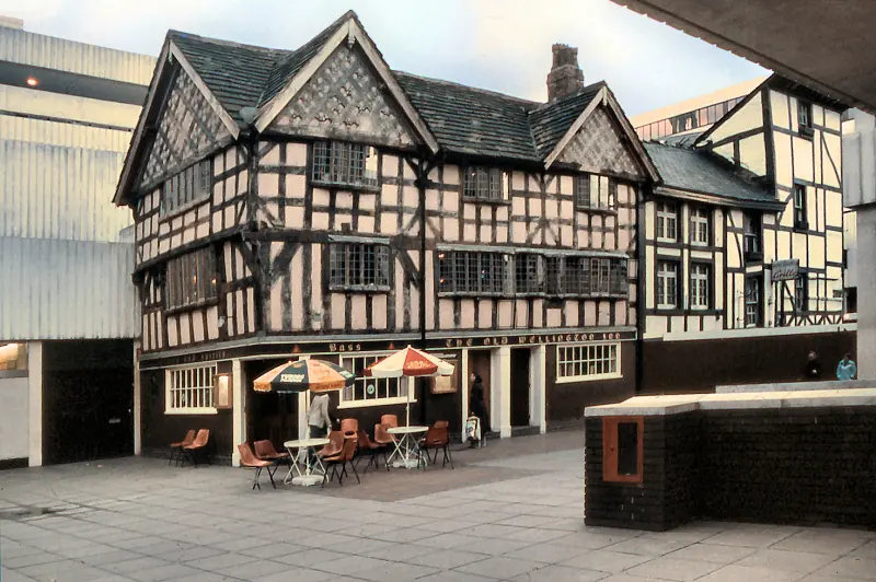The Old Wellington in 1977, standing on a brick podium among the concrete of a 1970s shopping precinct