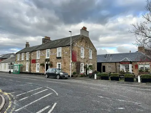 A long stone inn on a village street, THE ORIGINAL ROSSLYN INN lettered twice across its front
