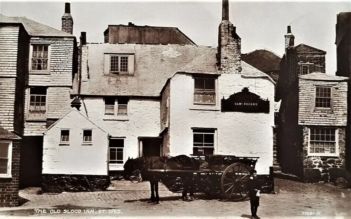 A horse and cart standing outside the whitewashed Sloop Inn in 1931, the landlord's name on the board above