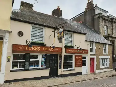 The same pub seen along the street, with its turban sign hung on an iron bracket