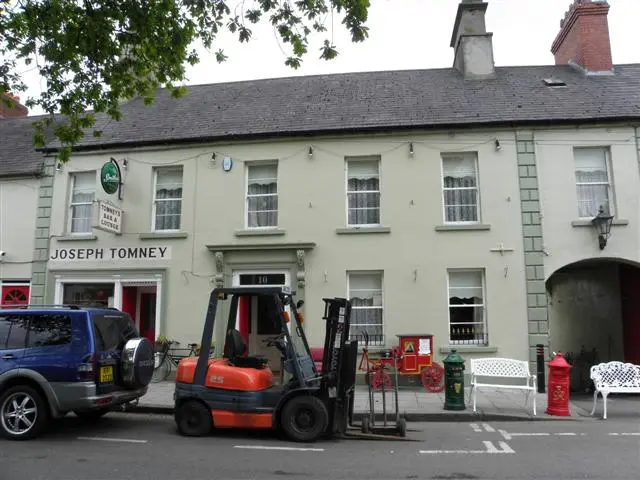 Cream terrace on the square, Joseph Tomney lettered over the shopfront and a Tomney's Bar sign above