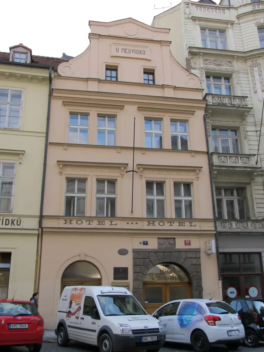 Pink baroque-gabled house lettered U Medvidku above three storeys of tall windows