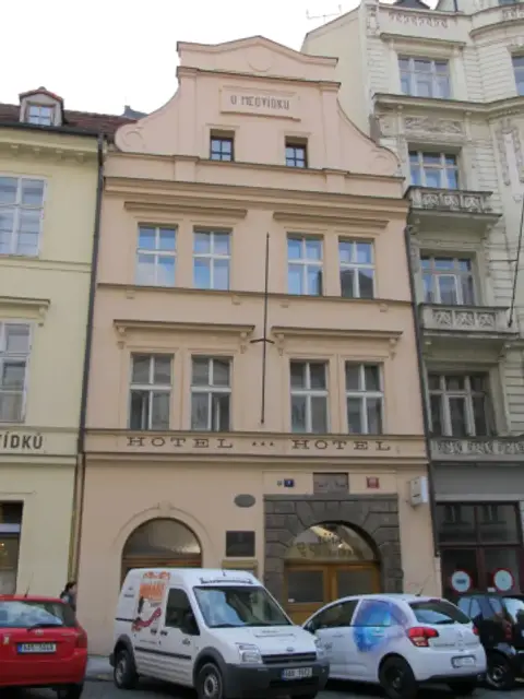 Pink baroque-gabled house lettered U Medvidku above three storeys of tall windows