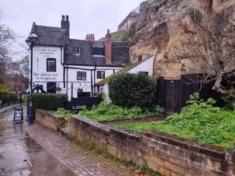 Ye Olde Trip to Jerusalem under the sandstone of Castle Rock, its gable painted 'the oldest inn in England'